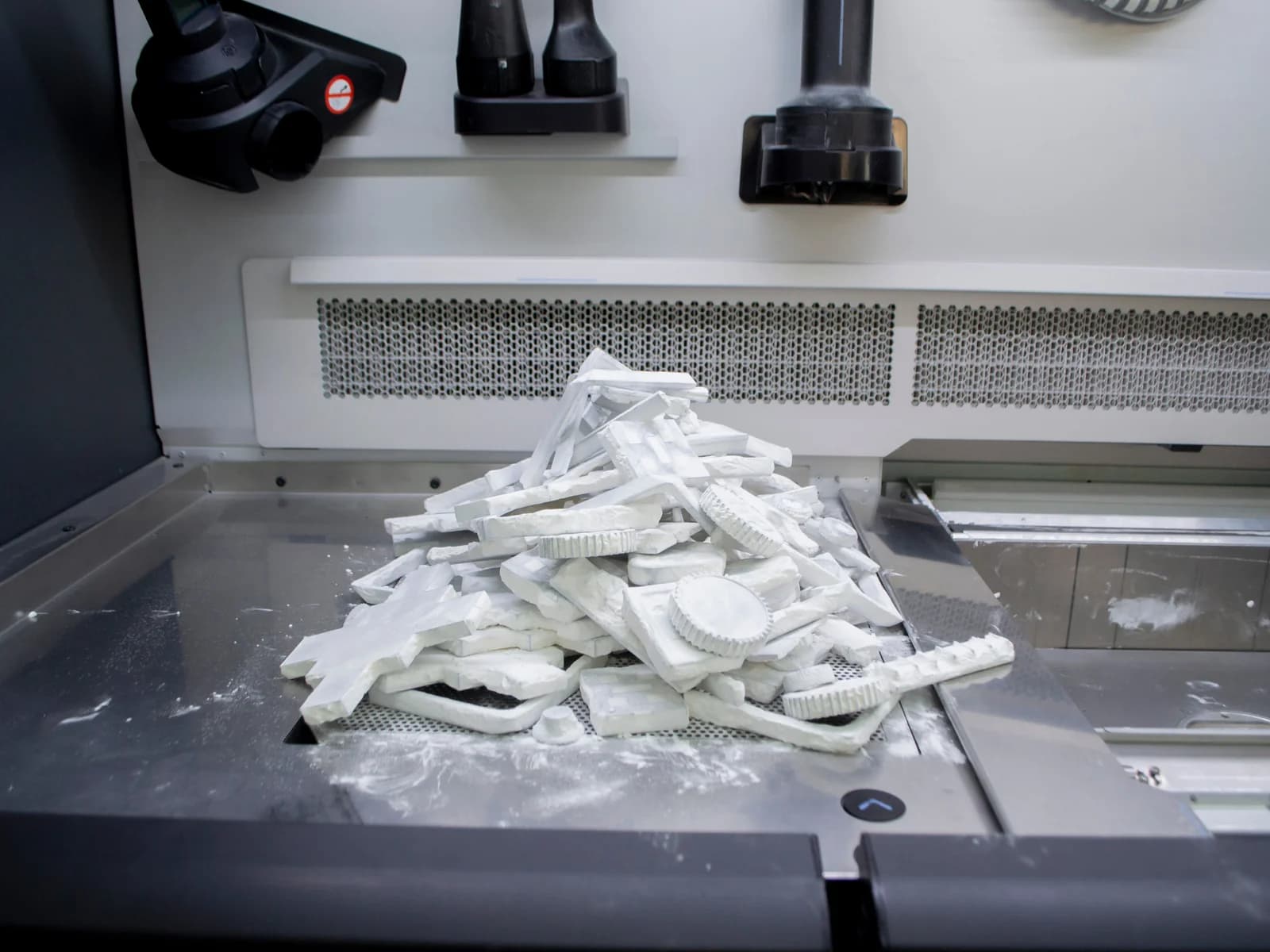 3D printed nylon parts being unpacked from powder